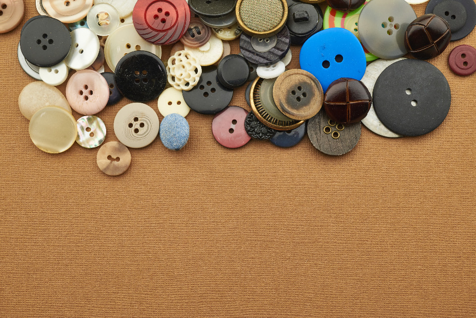 Buttons gathered on clay-colored cloth